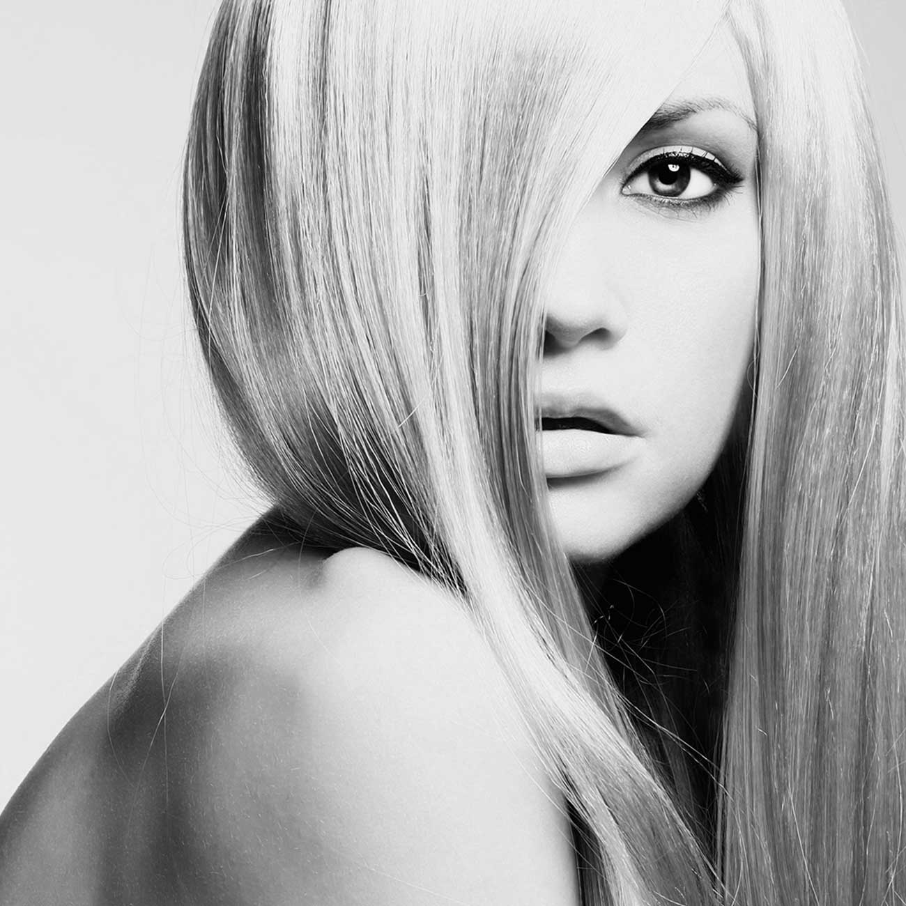 Blonde woman with styled hair at Blondology Salon Services in Hot Springs