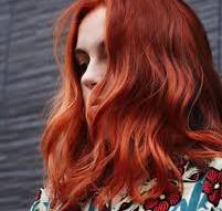 Model with vibrant red hair colored using Kevin Murphy hair color at Blondology Salon